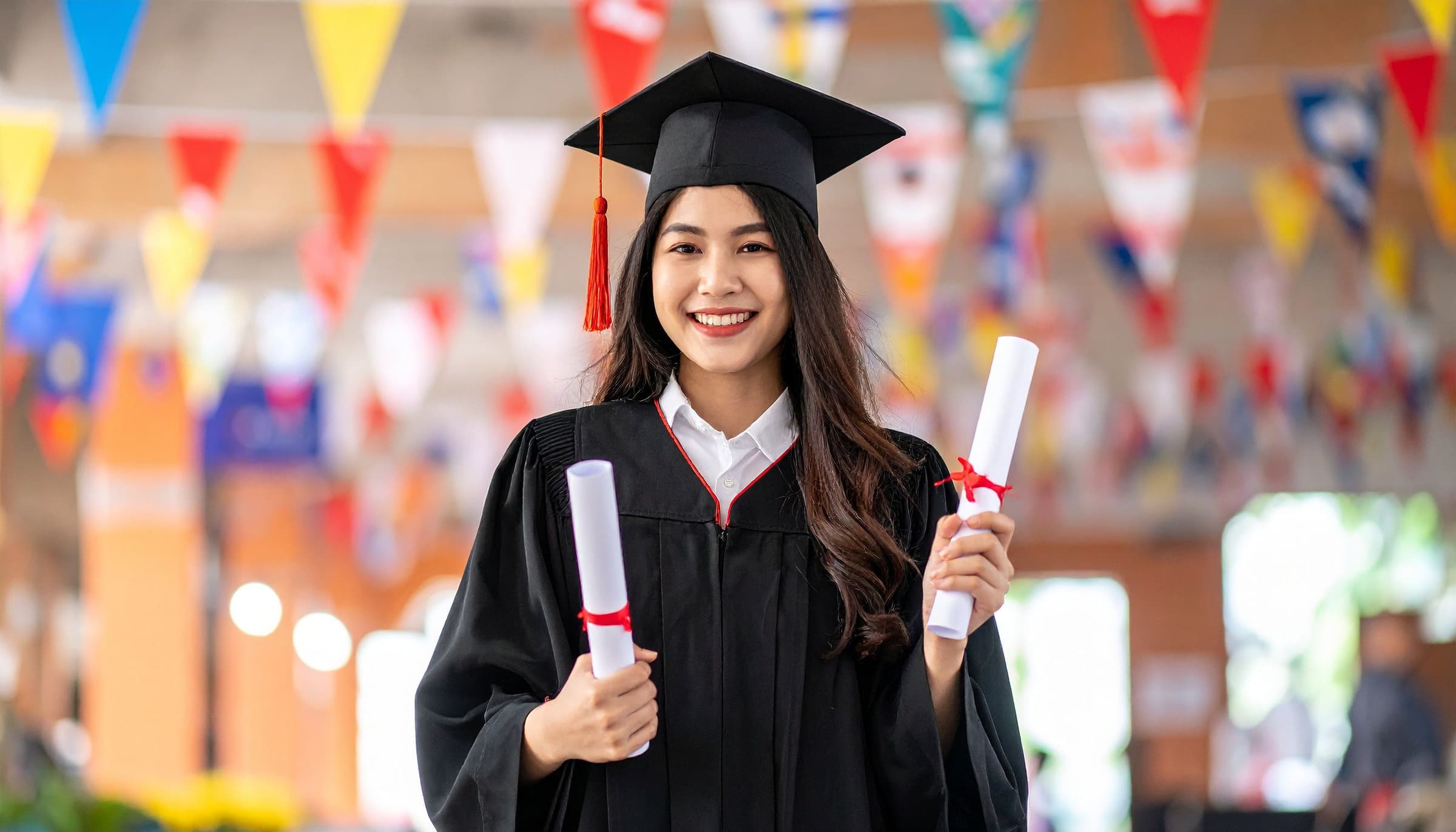 Female graduate holding a diploma